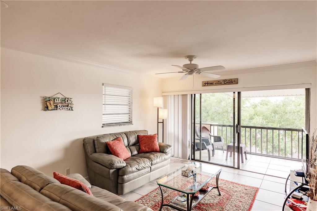 600 Neapolitan Way, Unit 454 Naples, FL 34103 - Photo 5 of 26 a living room with furniture and a window