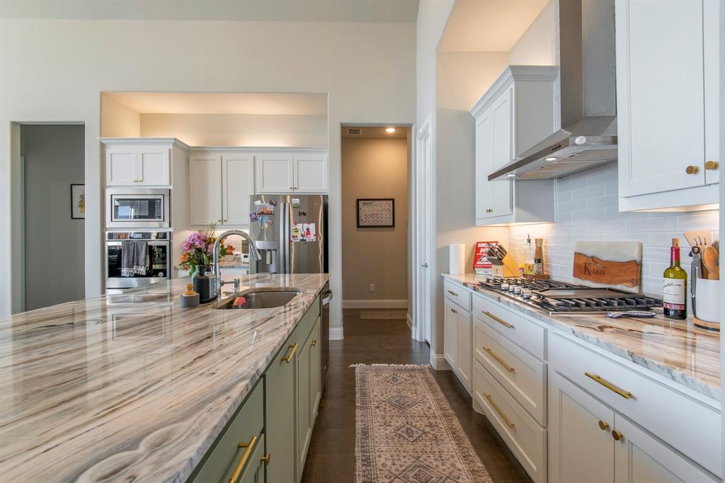 16650 Nightshade Road Frisco, TX 75033 - Photo 11 of 40 a kitchen with granite countertop lots of counter top space and stainless steel appliances