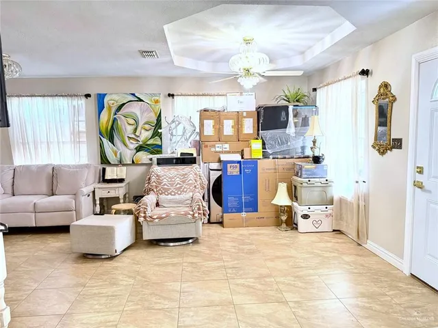 a living room with fireplace furniture and a chandelier