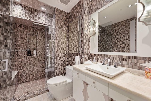 a bathroom with a sink toilet and shower