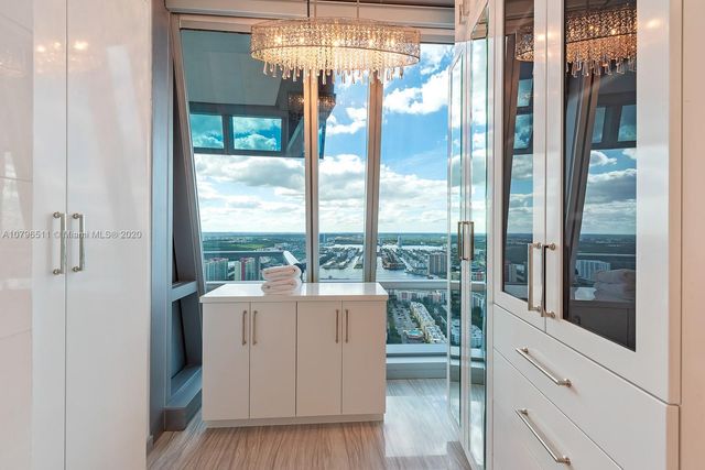 a very nice looking room with a large window and chandelier