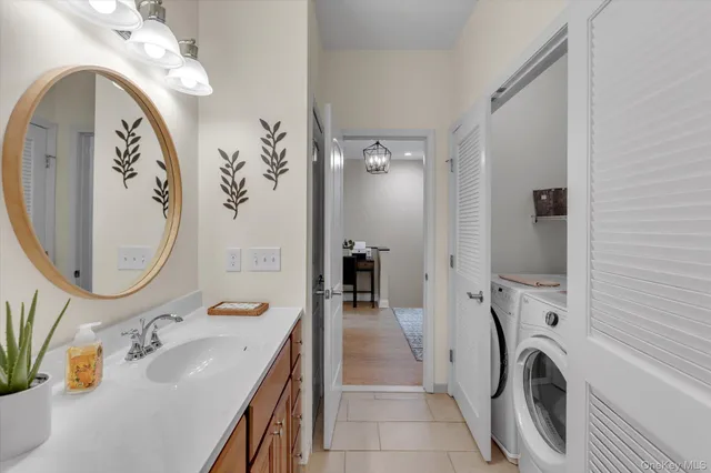 a bathroom with a sink a mirror and shower