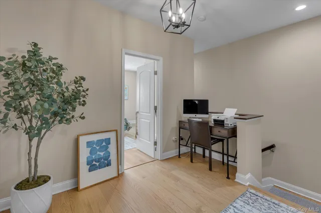 a view of a livingroom with furniture and a potted plant