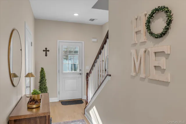 a view of entryway and hall with wooden floor