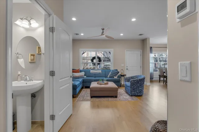 a living room with furniture a chandelier and a mirror