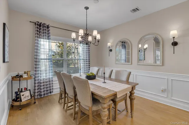 a view of a dining room with furniture and chandelier