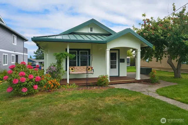 a front view of a house with a garden