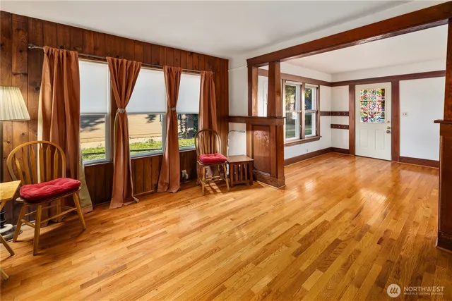 an empty room with large windows and furniture