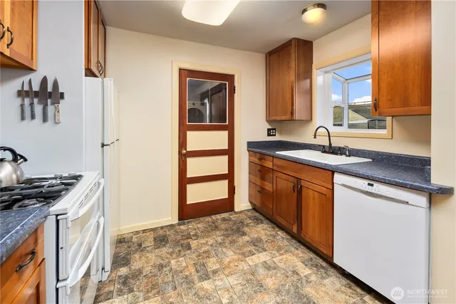 a kitchen with stainless steel appliances granite countertop a sink stove and cabinets