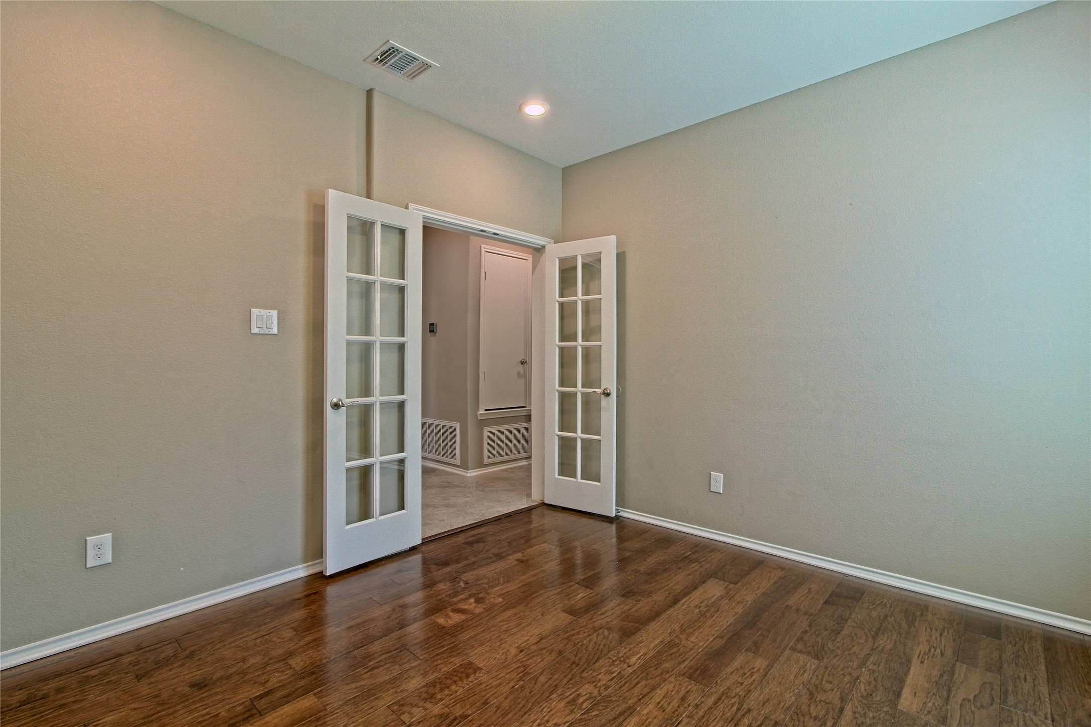 31443 Kingsway Road Georgetown, TX 78628 - Photo 19 of 40 French doors lead to a versatile study with lustrous hardwood flooring.
