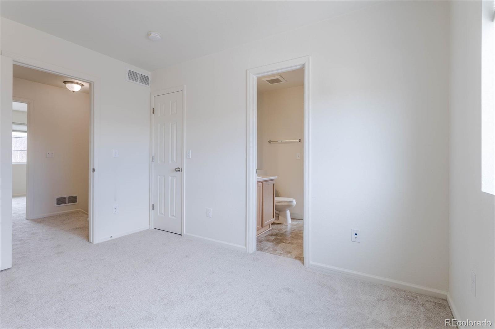 5559 Malta Street Denver, CO 80249 - Photo 11 of 27 wooden floor and closet in a room