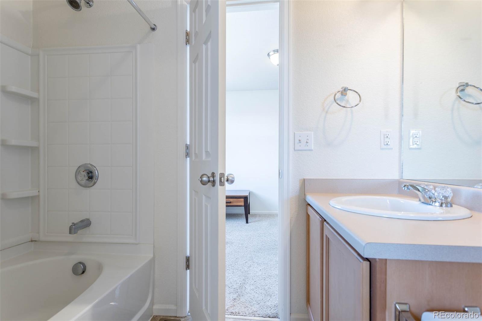 5559 Malta Street Denver, CO 80249 - Photo 13 of 27 a bathroom with a sink and a bathtub