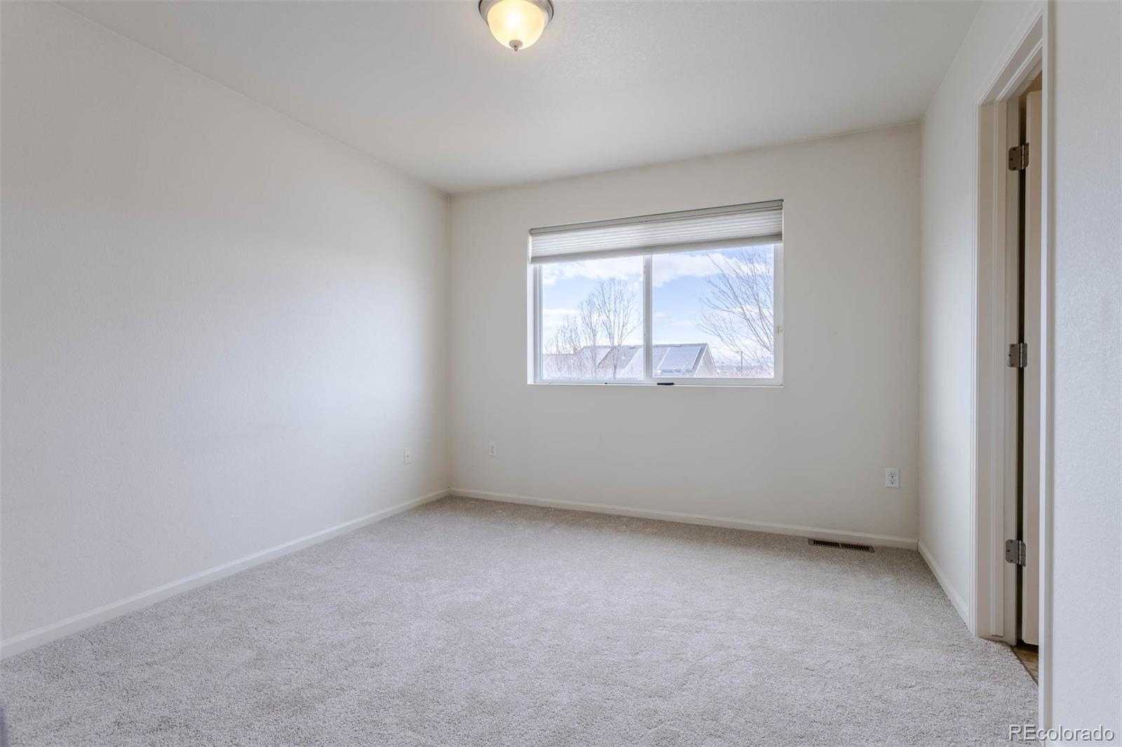 5559 Malta Street Denver, CO 80249 - Photo 14 of 27 an empty room with a window