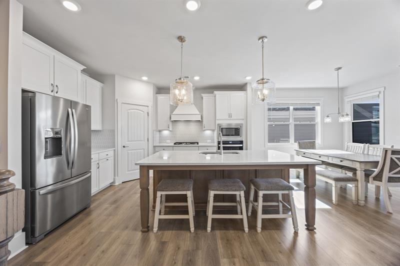 3431 Big View Road Gainesville, GA 30506 - Photo 11 of 59 a kitchen with stainless steel appliances granite countertop a kitchen island hardwood floor and a dining table