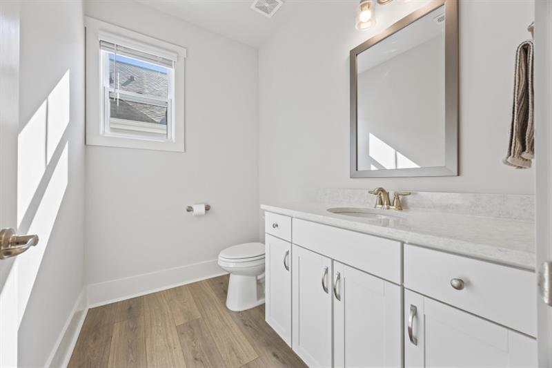 3431 Big View Road Gainesville, GA 30506 - Photo 25 of 59 a bathroom with a granite countertop toilet sink and mirror