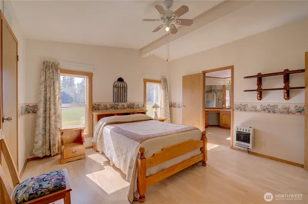 a bedroom with a bed and a mirror