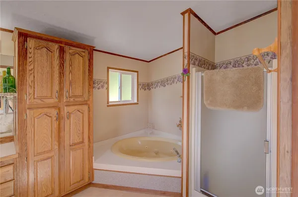a bathroom with a tub and shower