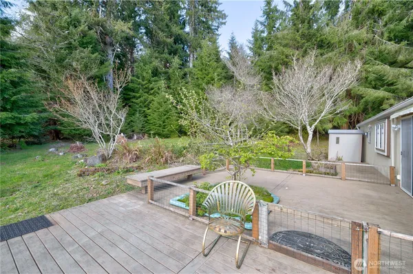a view of a patio with table and chairs with wooden floor and fence