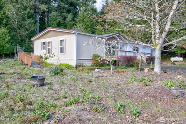 a view of a house with yard and a garden