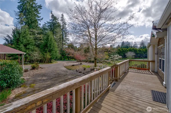 a view of a wooden deck and trees