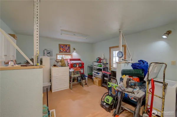 a view of play room with toys and a view of living room