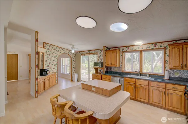 a large kitchen with a table and chairs