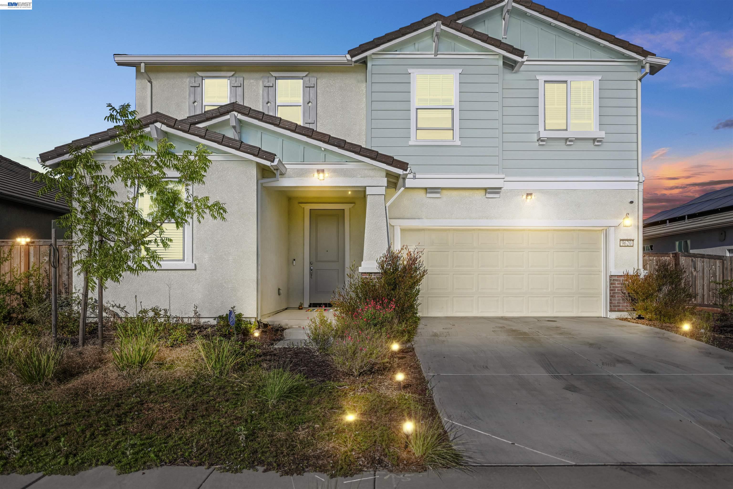 a view of a house with a small yard and plants