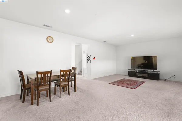 a view of a livingroom with furniture and a flat screen tv