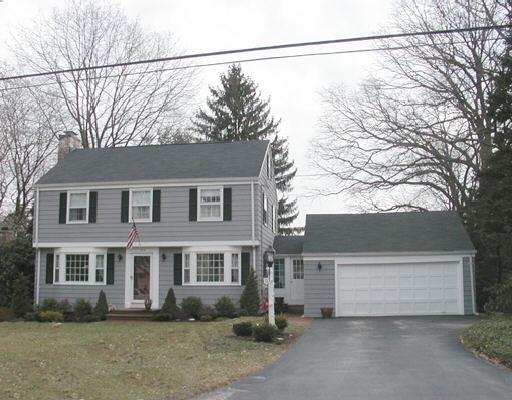 218 Mill River Road Fairfield, CT 06824 - Photo 1 of 1 a front view of a house with a yard and garage