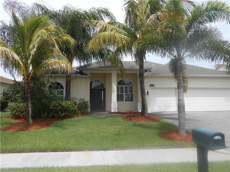 383 West Key Lime Square Southwest Vero Beach, FL 32968 - Photo 1 of 19 a front view of multi story residential apartment building with yard and green space