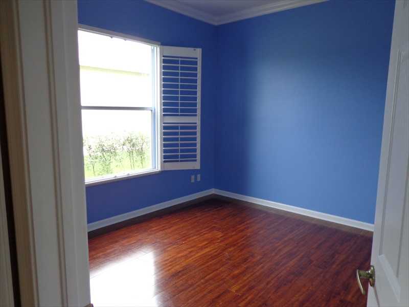 383 West Key Lime Square Southwest Vero Beach, FL 32968 - Photo 11 of 19 a view of an empty room with wooden floor and a window
