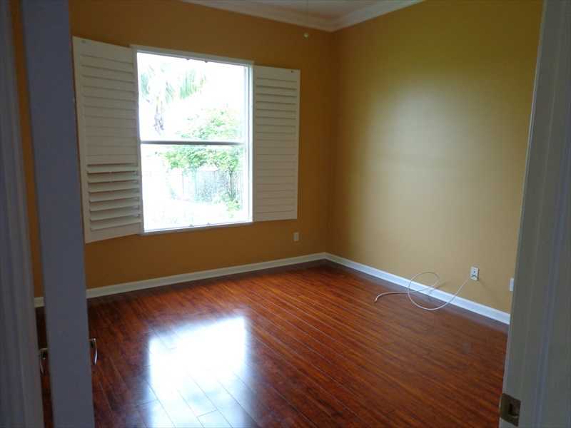 383 West Key Lime Square Southwest Vero Beach, FL 32968 - Photo 13 of 19 an empty room with wooden floor and windows