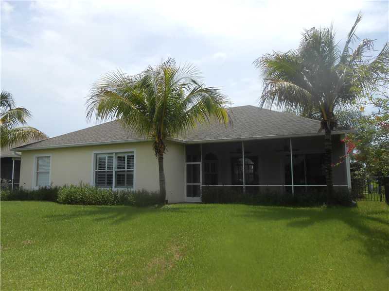 383 West Key Lime Square Southwest Vero Beach, FL 32968 - Photo 18 of 19 a view of a house with a yard and palm trees