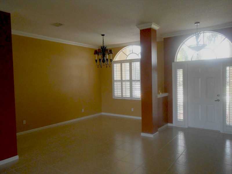 383 West Key Lime Square Southwest Vero Beach, FL 32968 - Photo 3 of 19 wooden floor in an empty room with a window