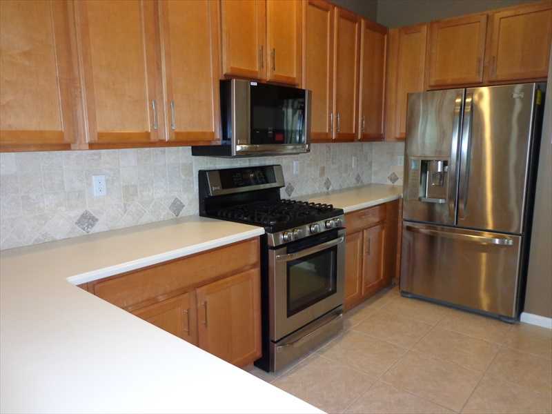 383 West Key Lime Square Southwest Vero Beach, FL 32968 - Photo 4 of 19 a kitchen with granite countertop a stove and a refrigerator