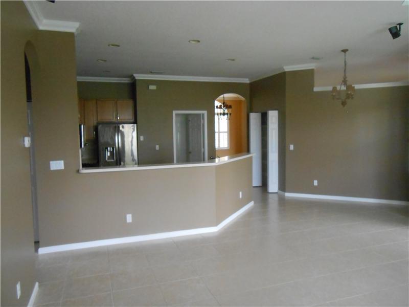 383 West Key Lime Square Southwest Vero Beach, FL 32968 - Photo 7 of 19 an empty room with mirror and fan
