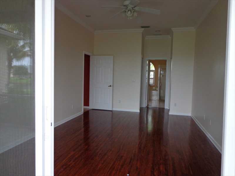 383 West Key Lime Square Southwest Vero Beach, FL 32968 - Photo 9 of 19 a view of an empty room with wooden floor and a window