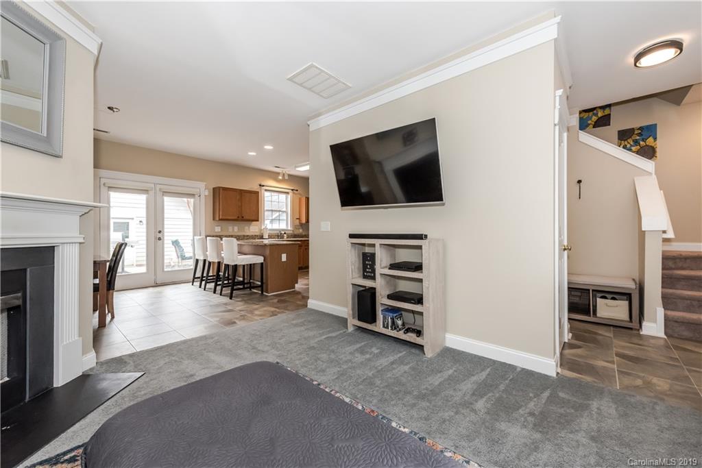 249 Faust Road Davidson, NC 28036 - Photo 11 of 36 a living room with furniture and a flat screen tv