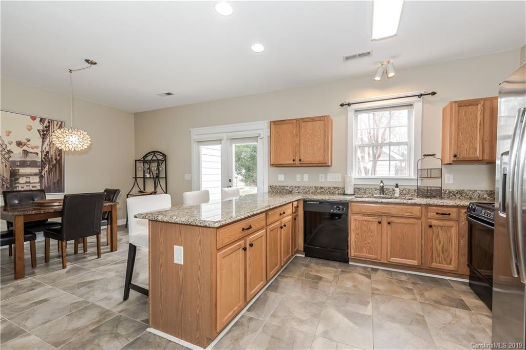 249 Faust Road Davidson, NC 28036 - Photo 15 of 36 a kitchen with stainless steel appliances granite countertop lots of counter top space and furniture