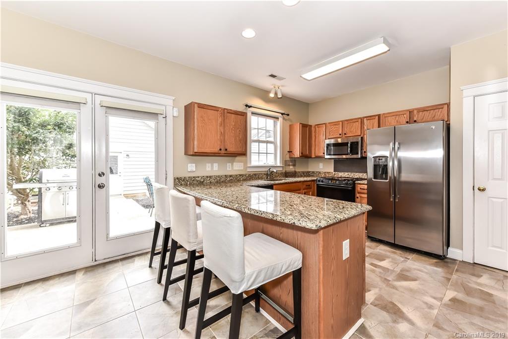 249 Faust Road Davidson, NC 28036 - Photo 16 of 36 a kitchen with kitchen island a counter top space appliances and a cabinets