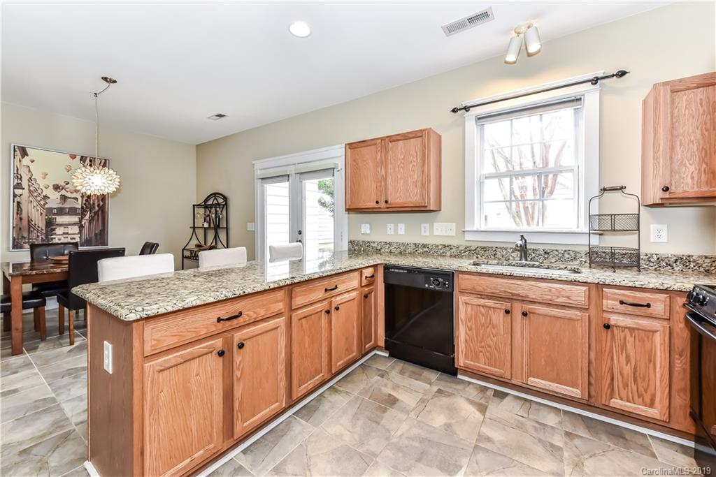 249 Faust Road Davidson, NC 28036 - Photo 17 of 36 a kitchen with granite countertop cabinets sink and window