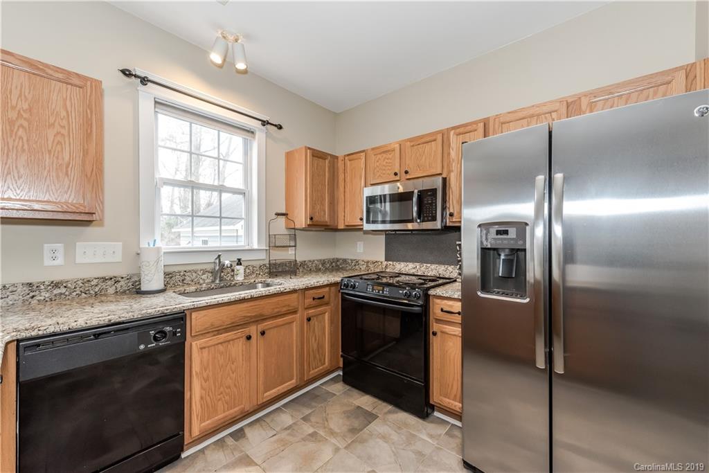 249 Faust Road Davidson, NC 28036 - Photo 18 of 36 a kitchen with stainless steel appliances granite countertop a stove a sink dishwasher a refrigerator and a microwave oven