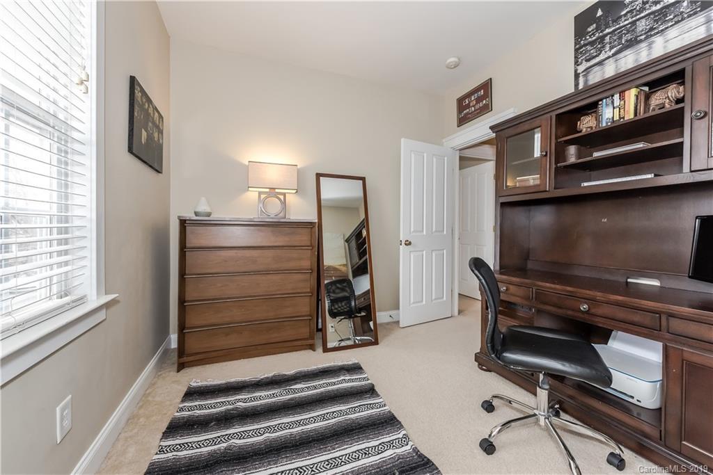 249 Faust Road Davidson, NC 28036 - Photo 22 of 36 a room with a chair and a stove top oven