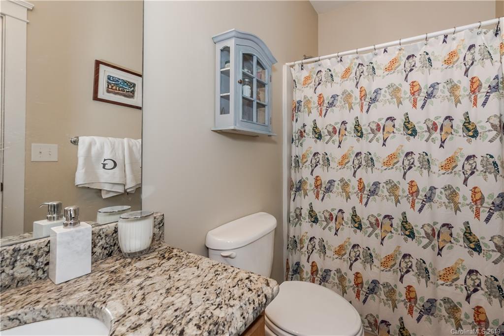 249 Faust Road Davidson, NC 28036 - Photo 24 of 36 a bathroom with a toilet and a shower curtain