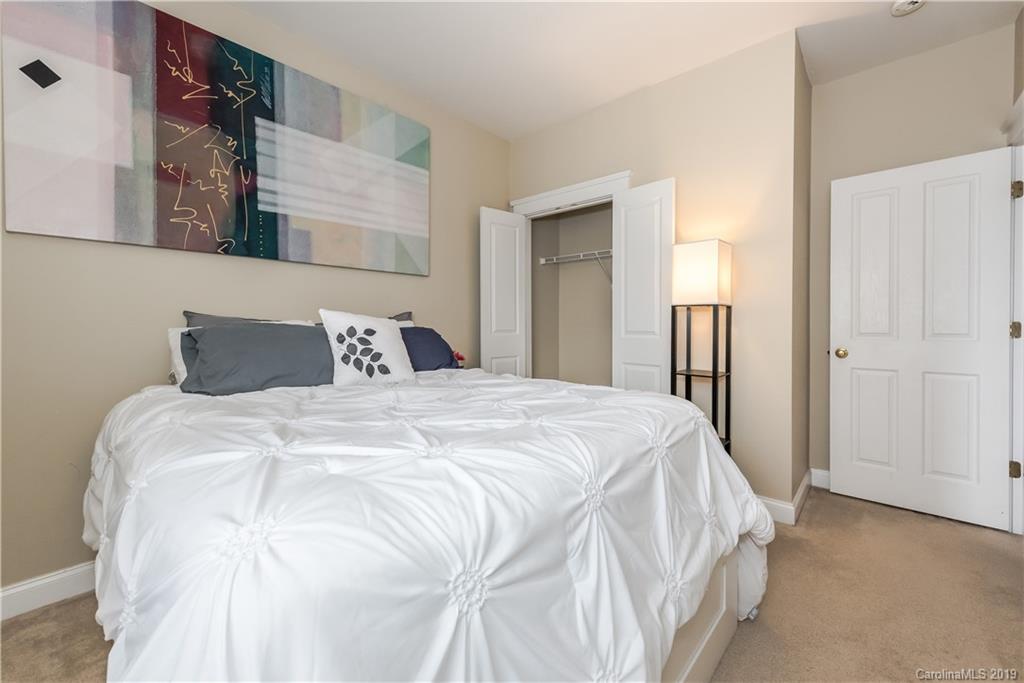 249 Faust Road Davidson, NC 28036 - Photo 26 of 36 a bedroom with a bed and a night stand