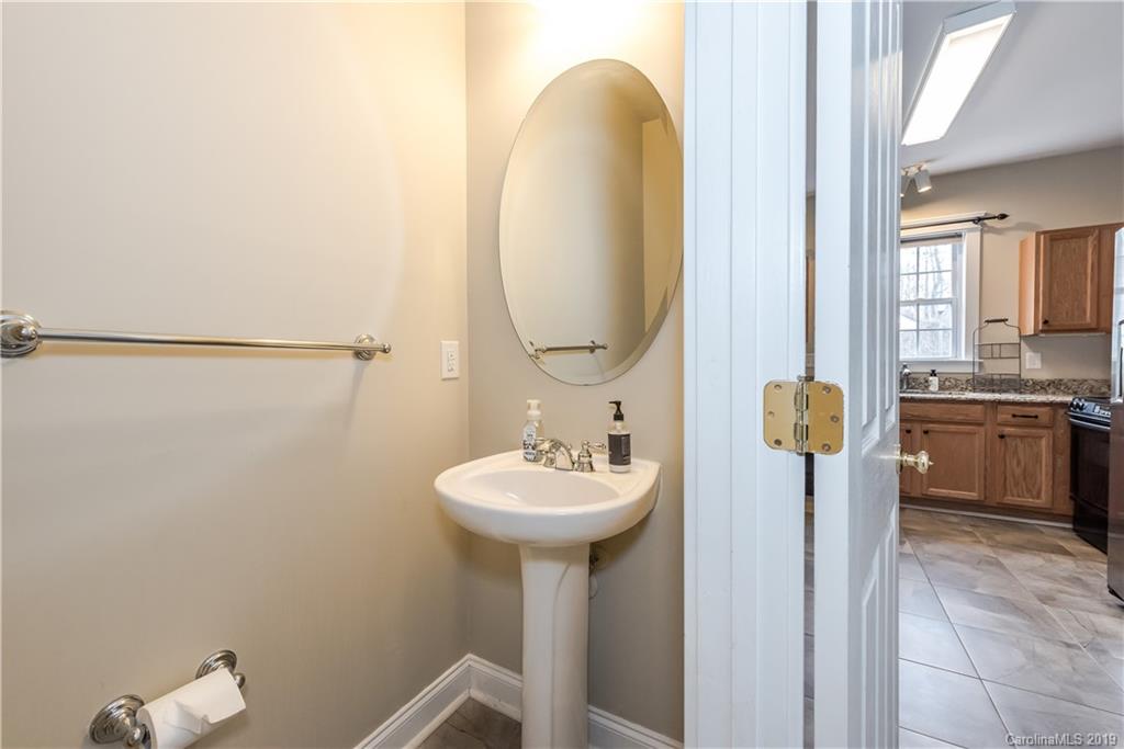 249 Faust Road Davidson, NC 28036 - Photo 6 of 36 a bathroom with a sink a toilet and a mirror