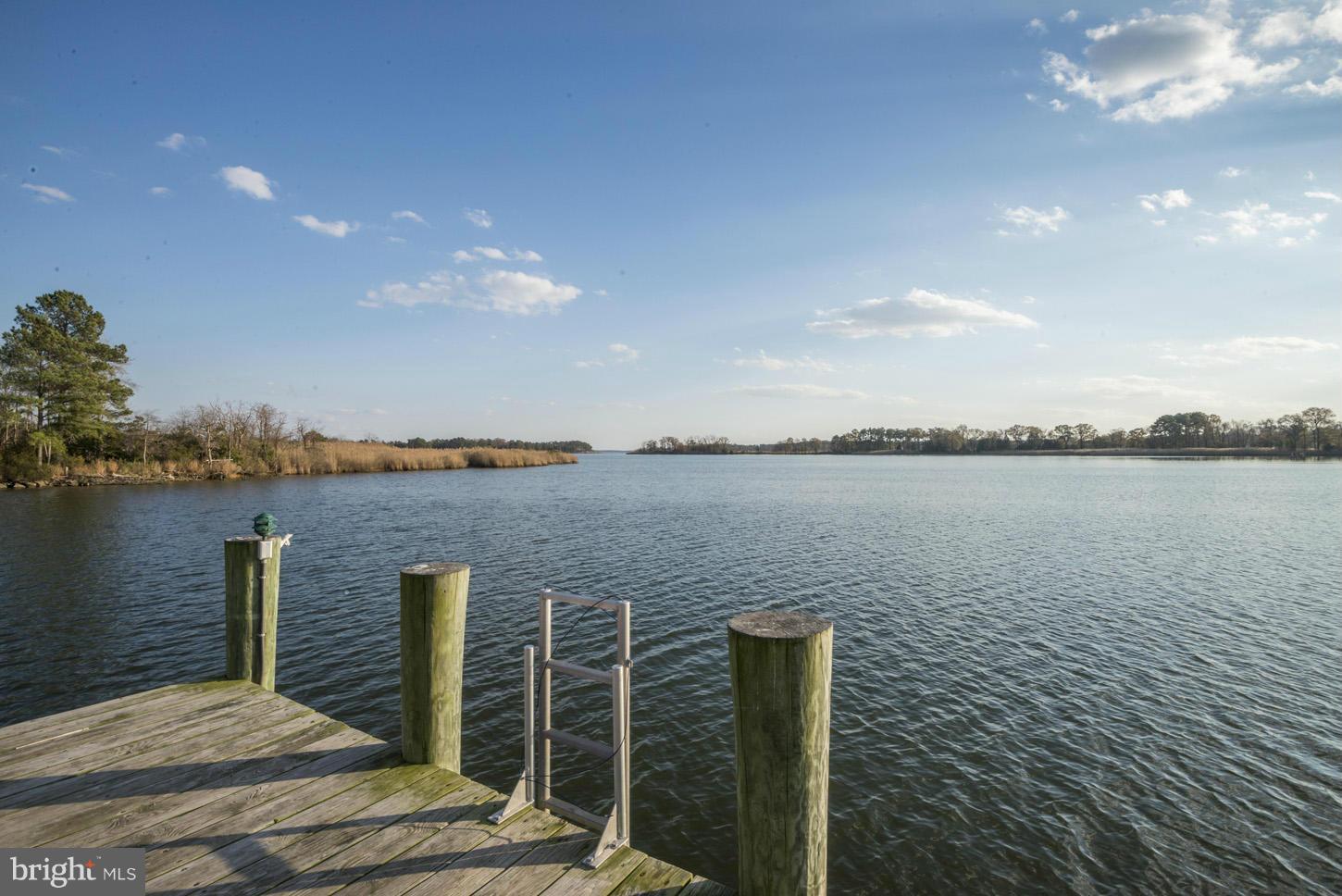4940 Skinners Neck Road Rock Hall, MD 21661 - Photo 2 of 30 a terrace with outdoor seating and lake view