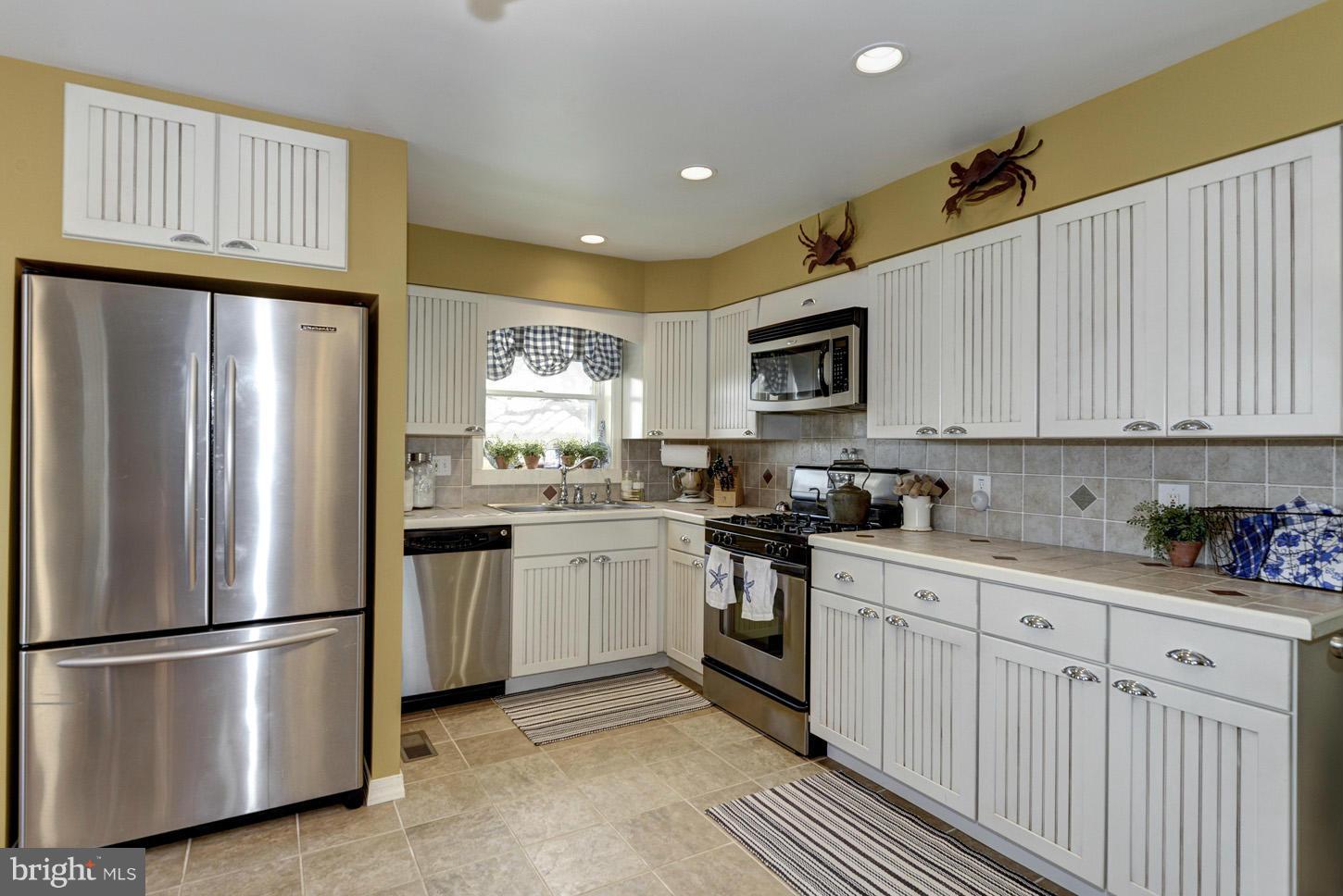 4940 Skinners Neck Road Rock Hall, MD 21661 - Photo 12 of 30 a kitchen with stainless steel appliances granite countertop a refrigerator sink and stove