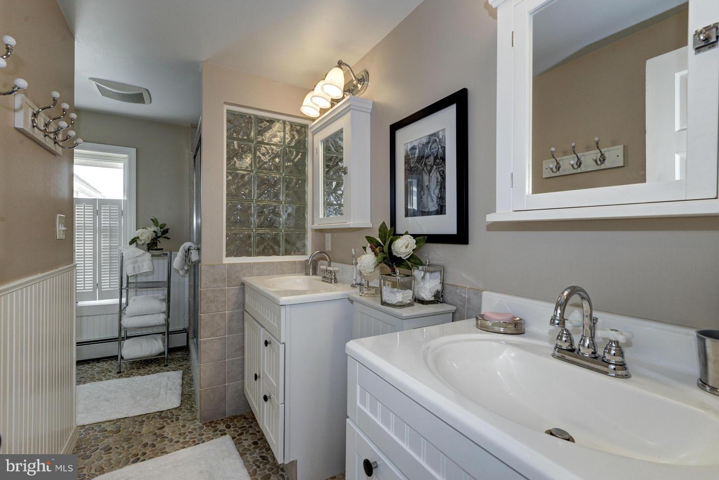 4940 Skinners Neck Road Rock Hall, MD 21661 - Photo 16 of 30 a bathroom with 2 sink and a mirror