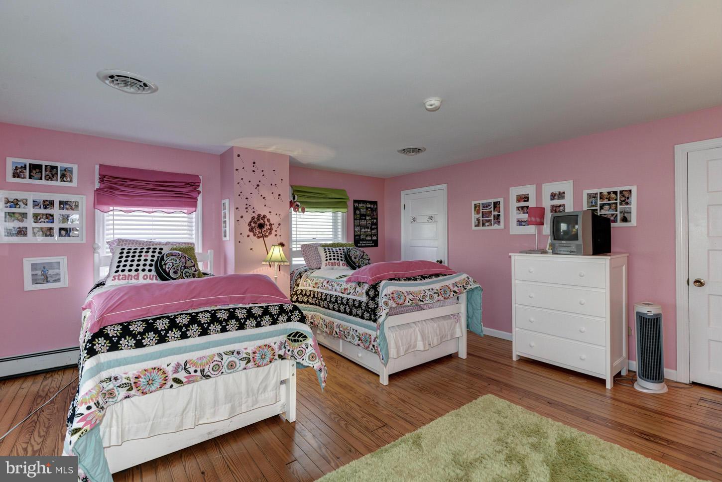 4940 Skinners Neck Road Rock Hall, MD 21661 - Photo 17 of 30 a bedroom with a bed and a dresser